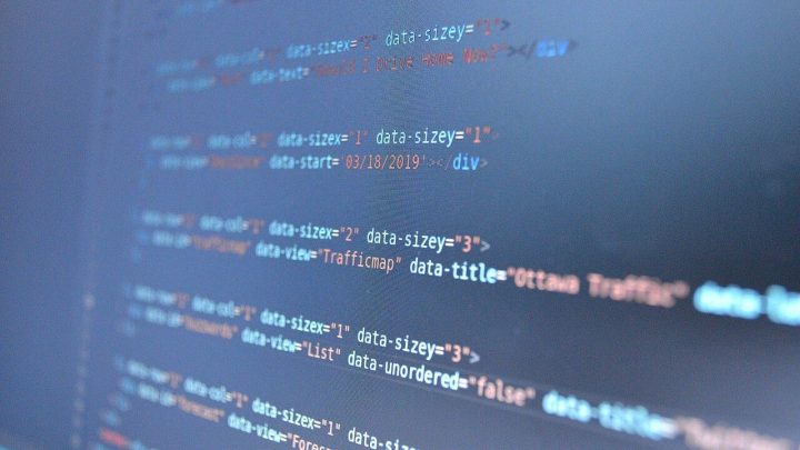 Blue lines of code on a monitor, slightly out of focus