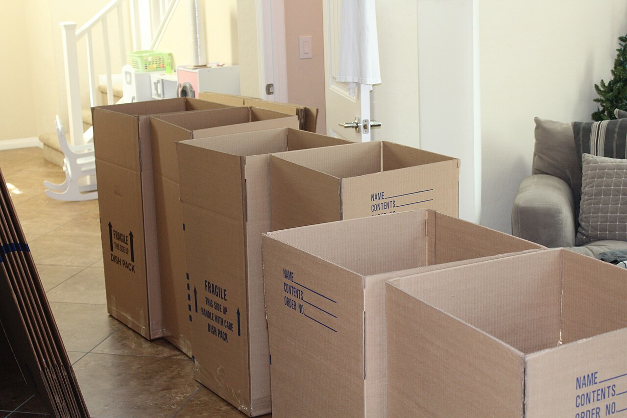 Stacked cardboard boxes ready for shipping in a room